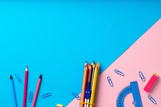Back to school. Scattered stationery on paper background top view