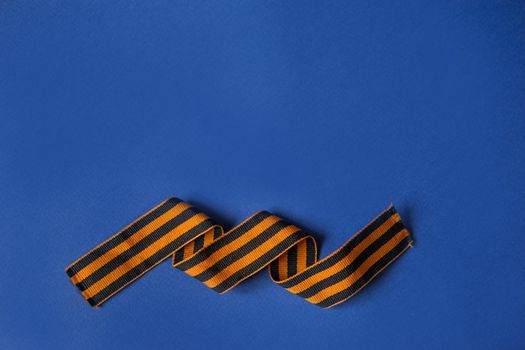 Tver Russia-may 9, 2020: 75 years of Victory in the great Patriotic war. St. George ribbon for 75 years of victory on a blue background. Happy Victory Day Space for text.