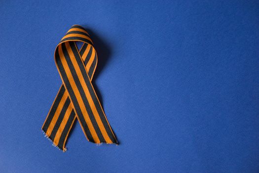 Tver Russia-may 9, 2020: 75 years of Victory in the great Patriotic war. St. George ribbon for 75 years of victory on a blue background. Happy Victory Day Space for text.