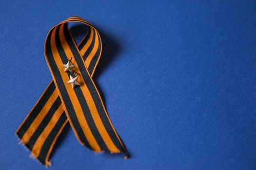 Tver Russia-may 9, 2020: 75 years of Victory in the great Patriotic war. St. George ribbon for 75 years of victory on a blue background. Happy Victory Day Space for text.