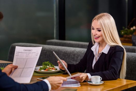 A woman and a man on a business lunch in a restaurant