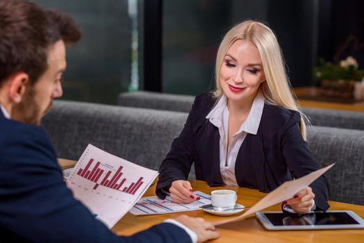 A woman and a man on a business lunch in a restaurant