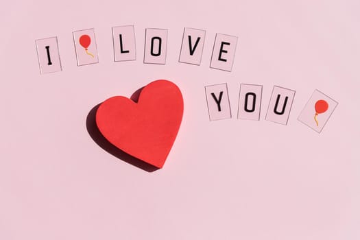 'I love you' text written on card and red hearts