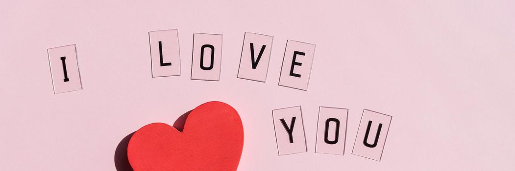 'I love you' text written on card and red hearts
