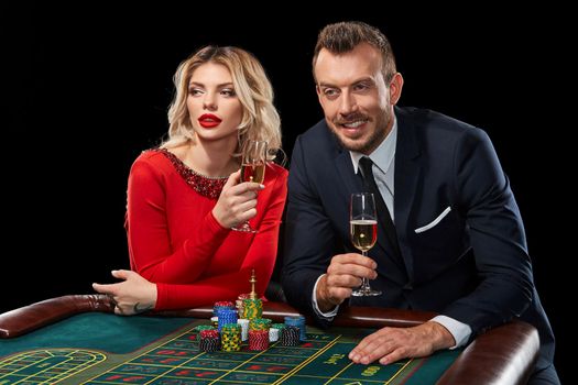 Couple playing roulette wins at the casino. Addiction to the gambling. celebrating the victory and win