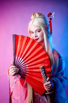 the a woman in a geisha costume with a katana and a fan
