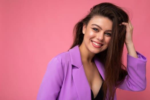 Photo of smiling young business woman wearing purple suit isolated on background. Copy space.