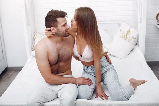 Woman in a sexy underwear. Couple at home.