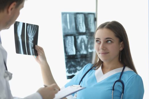 Doctors look at xrays in medical office. Medical council concept