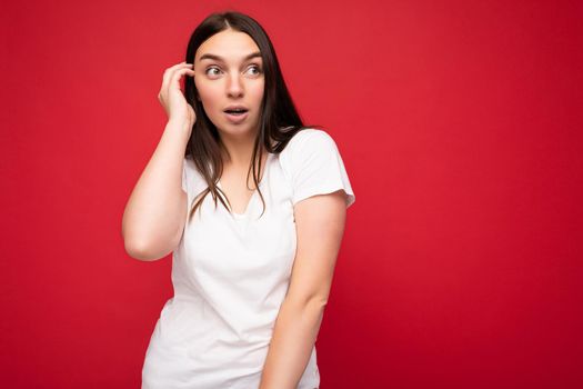 Closeup photo of beautiful attractive shocked amazed surprised young woman with open mouth wearing casual clothes isolated over colourful background with empty space.