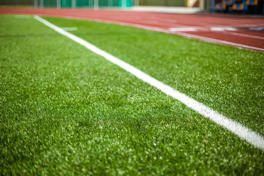 White line on a soccer field grass. Sports stadium in the open air