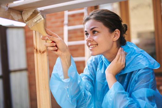 woman house painter renovating wood fittings at home. High quality photo