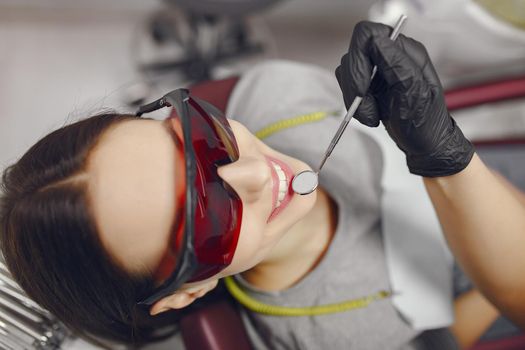 Beautiful lady in the dentist's office. Brunette sitting in a chair