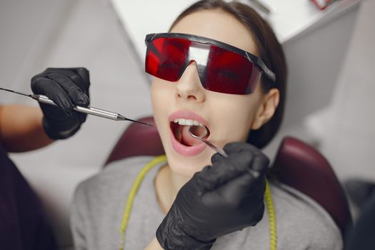 Beautiful lady in the dentist's office. Brunette sitting in a chair