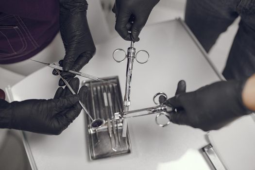 Tools in a hands. Dentist holds instruments