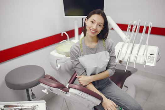 Beautiful lady in the dentist's office. Brunette sitting in a chair