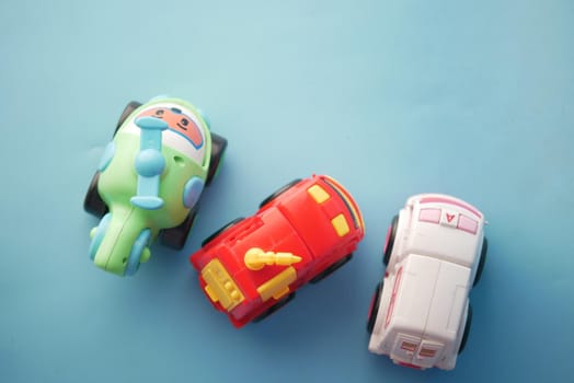 colorful plastic toys on blue background .
