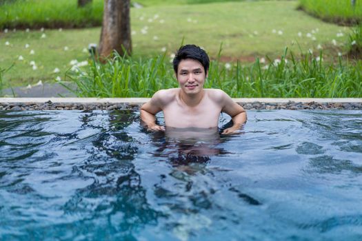 young man playing in the swimming pool