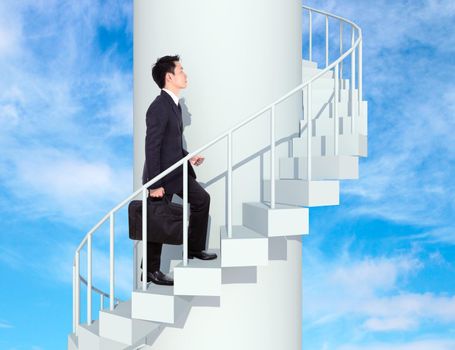 business man going upstairs in a curved staircase to success with blue sky background