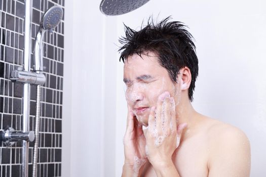 man washing face in the bathroom at home