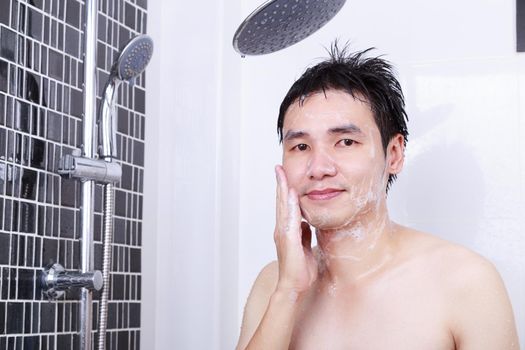 man washing face in the bathroom at home