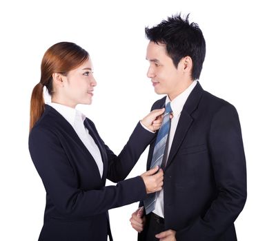 business woman's hands adjusting neck tie of man in suit isolated on white background