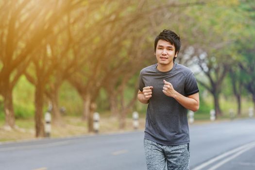 young fitness man running in the park