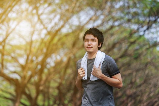 young fitness man running in the park