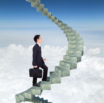 business man going upstairs in a curved staircase to success with blue sky background