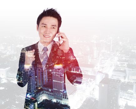 double exposure of happy businessman talking on smartphone with a city background