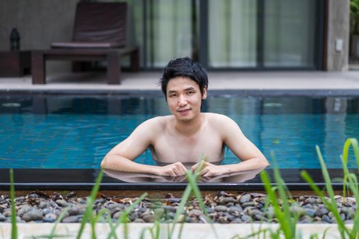 young man playing in the swimming pool