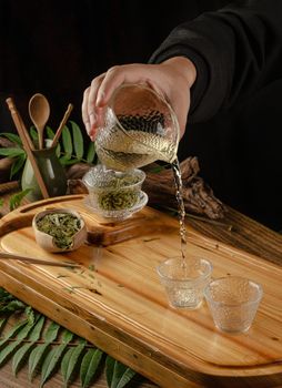 the tea table with instruments teapots cups pancake and tea Shen Puer