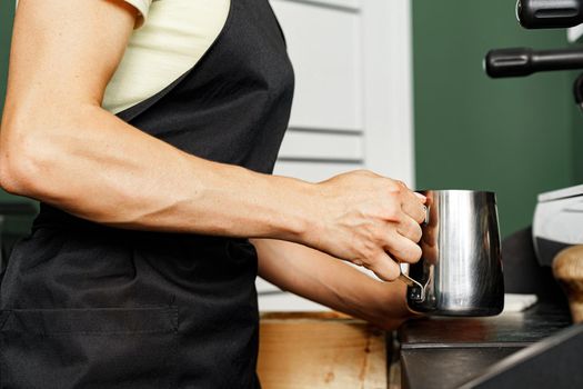 Woman coffee shop worker preparing coffee on professional coffee machine close up