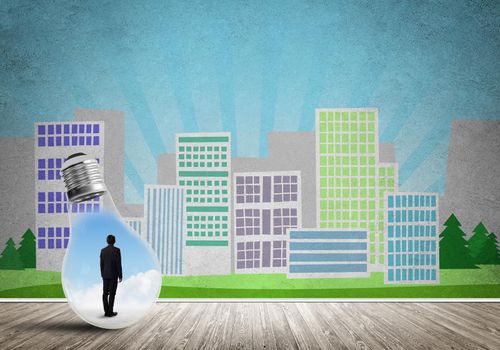 Businessman inside light bulb against city drawn concept