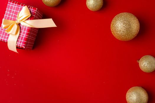 Christmas baubles and wrapped gift decorated with bow top view