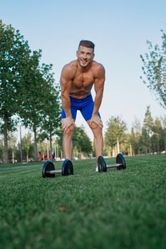 sporty man in park exercise crossfit workout. High quality photo