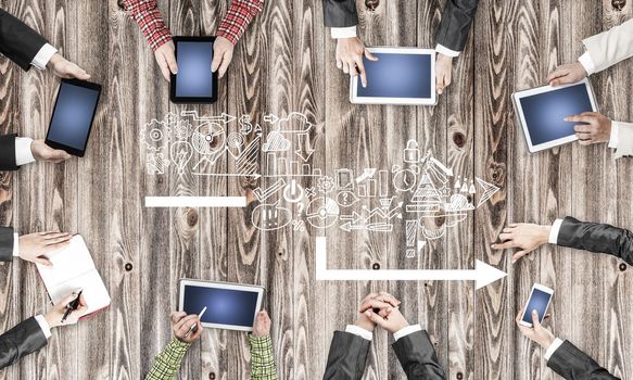 Group of people with devices in hands working together as symbol of networking and communication