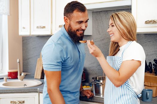 Couple in love preparing meal together in kitchen at home