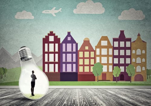 Businesswoman inside light bulb against city drawn concept