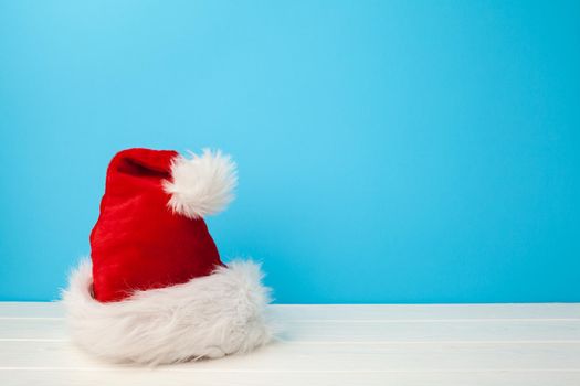 Red hat of a Santa Claus against blue background front view