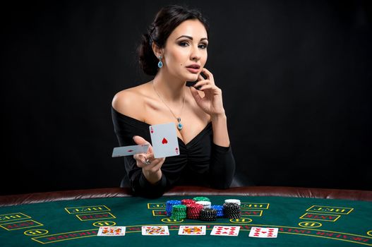 sexy woman with poker cards. Female player in a beautiful black dress and throwing two aces