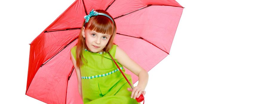 A little girl with long blond hair and a short bangs, in a short summer dress.The girl closed from the sun and rain under a red umbrella.