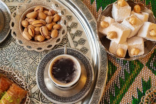 Traditional arabic dessert baklava with a cup of turkish coffee, close up