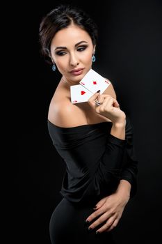 sexy woman with poker cards. Female player in a beautiful black dress