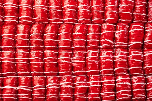 Red colored Turkish dessert baklava placed in rows, for background