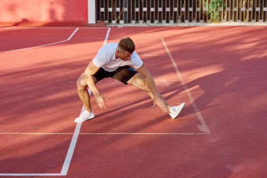 man on the sports ground exercise warm-up lifestyle. High quality photo