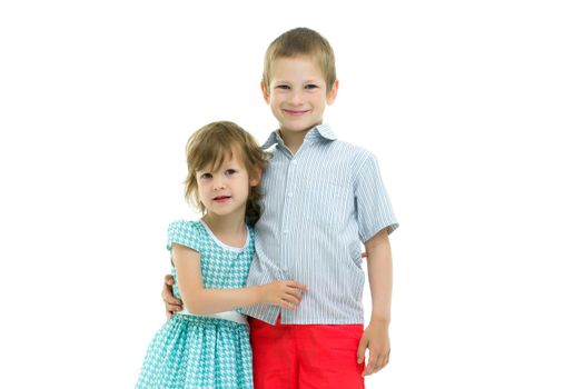 Boy and girl, brother and sister posing in the studio. Concept of family values, friendship, game. Isolated on white background