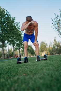 sporty man in park exercise crossfit workout. High quality photo