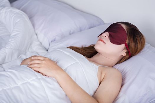 beautiful woman sleeping on bed with eye mask