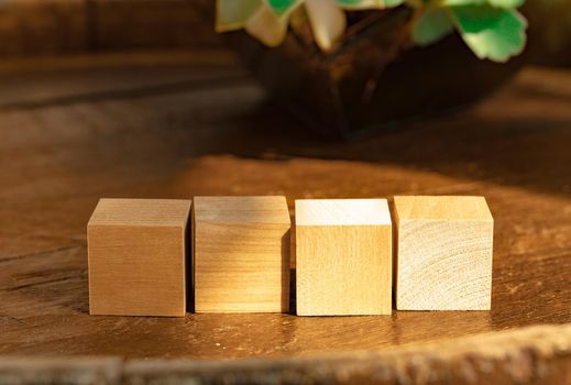 Groupped wooden square blocks on dark wooden table, copy space